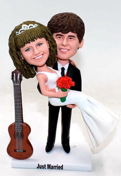 Custom cake topper holding bride with guitar