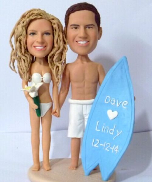Beach themed wedding cake topper with surfboard