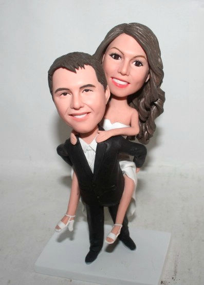 Custom cake topper groom carrying bride wedding figurines