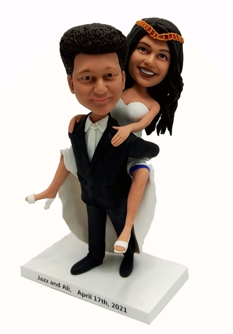 Custom wedding cake toppers one carrying another
